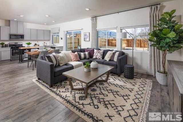 living room with recessed lighting and light wood-style floors