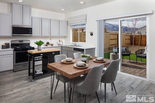 interior space featuring recessed lighting, light wood-type flooring, and baseboards