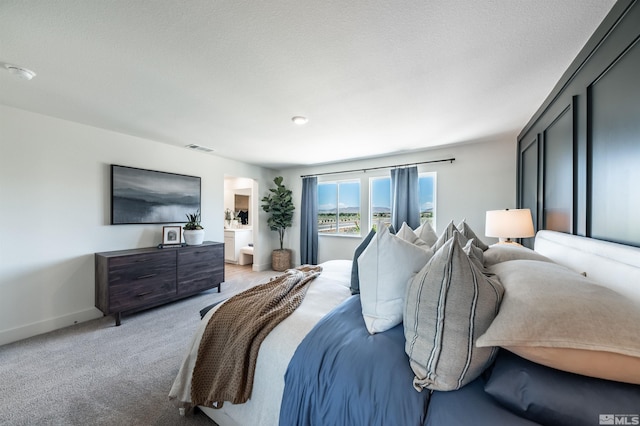 bedroom featuring baseboards, visible vents, and light carpet