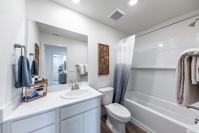 bathroom with visible vents, toilet, shower / bath combo, and vanity