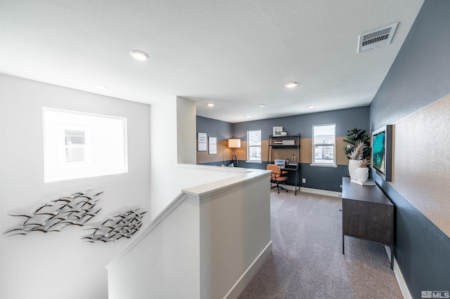 hall with visible vents, an upstairs landing, recessed lighting, carpet floors, and baseboards