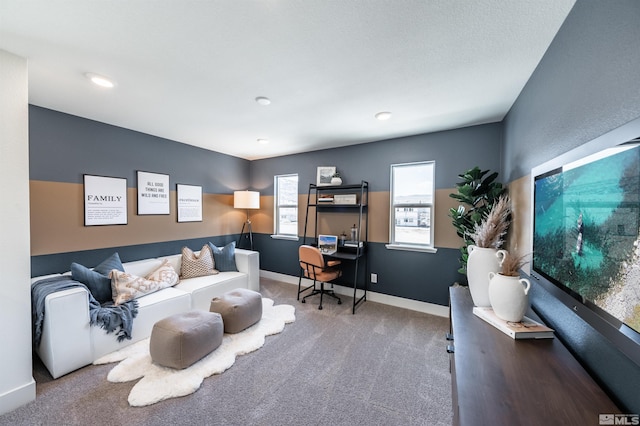 carpeted living area with baseboards