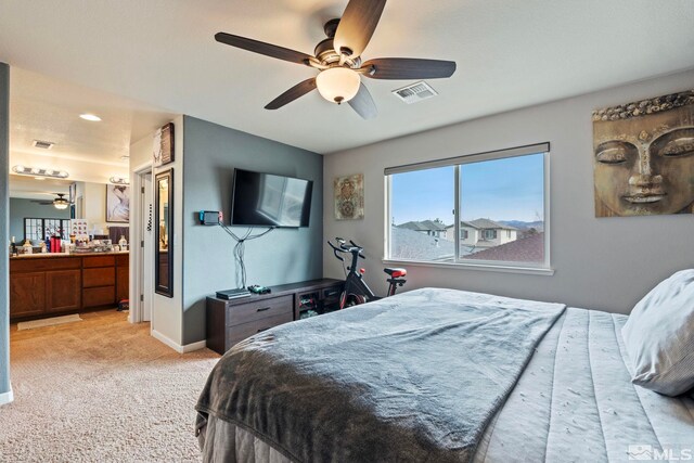 bedroom featuring visible vents, baseboards, light colored carpet, and a ceiling fan