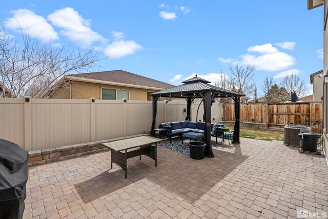 view of patio / terrace with a gazebo, an outdoor living space, a fenced backyard, and central AC