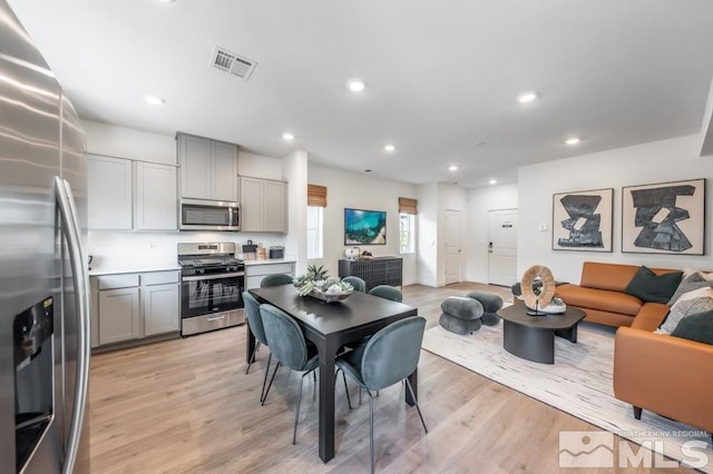 dining room with recessed lighting, visible vents, and light wood finished floors