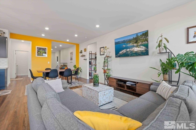 living room with recessed lighting, wood finished floors, and baseboards