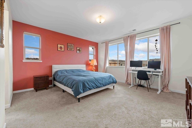 carpeted bedroom featuring visible vents and baseboards