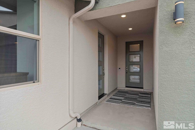 property entrance featuring stucco siding