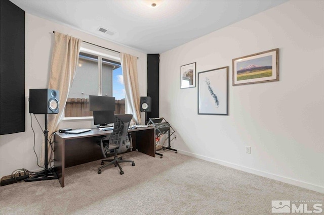 carpeted office featuring visible vents and baseboards