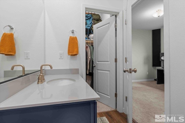 bathroom with baseboards and vanity