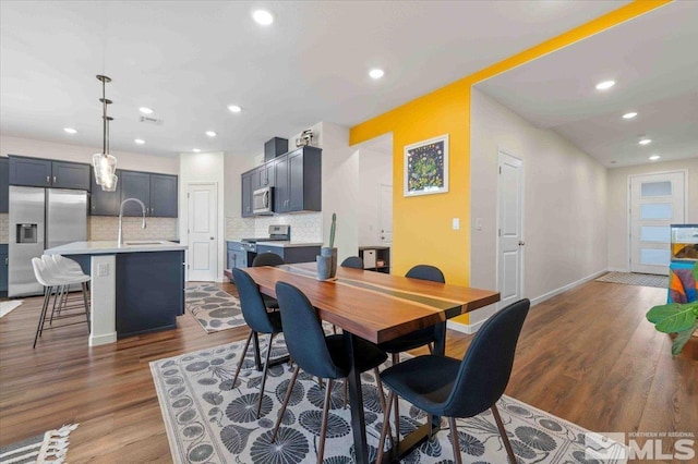 dining space with recessed lighting, visible vents, baseboards, and wood finished floors