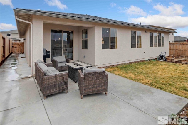 back of property featuring stucco siding, a patio area, fence, and an outdoor hangout area