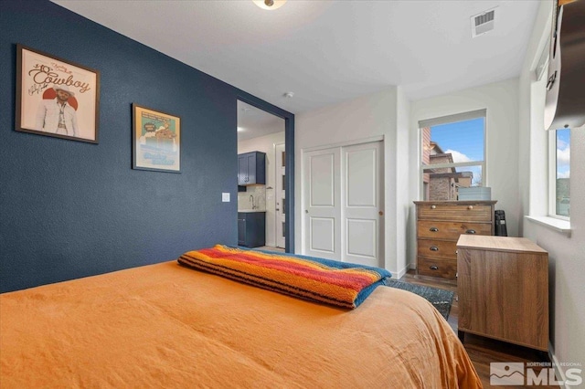 bedroom featuring a closet and visible vents