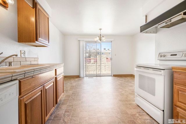 kitchen featuring tile counters, under cabinet range hood, brown cabinetry, white appliances, and a sink