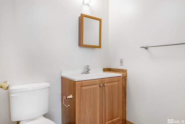 bathroom featuring toilet and vanity