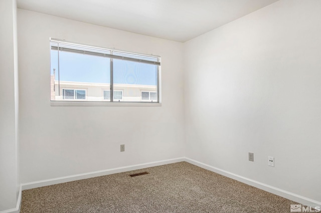 spare room with visible vents, baseboards, and carpet flooring