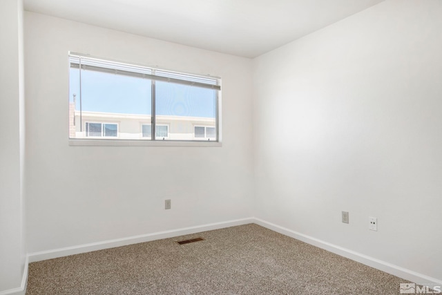 unfurnished room with visible vents, baseboards, and carpet