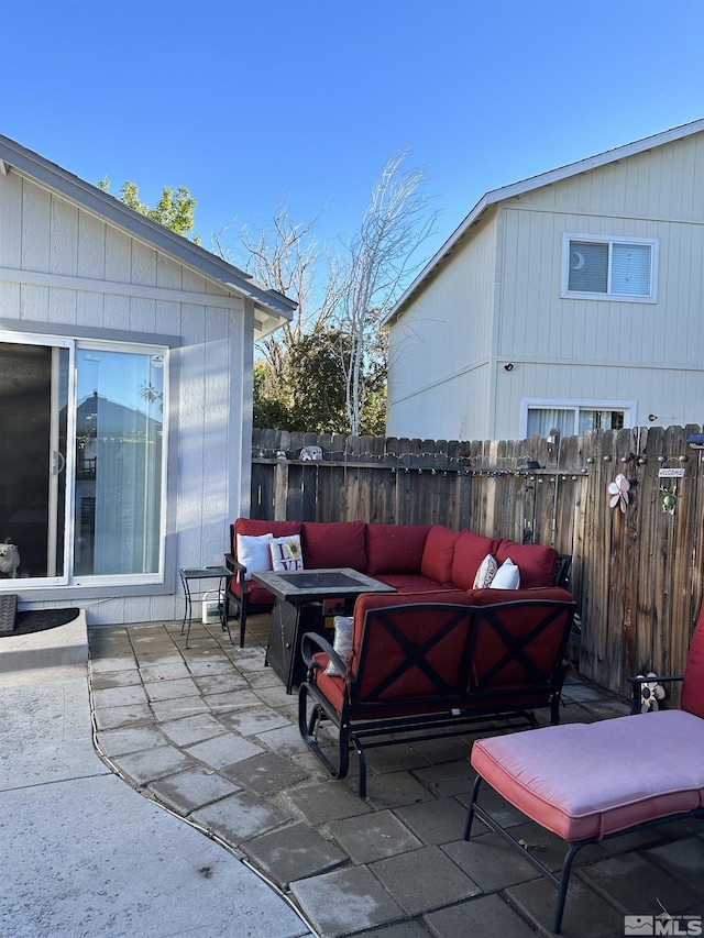 view of patio featuring an outdoor living space and fence