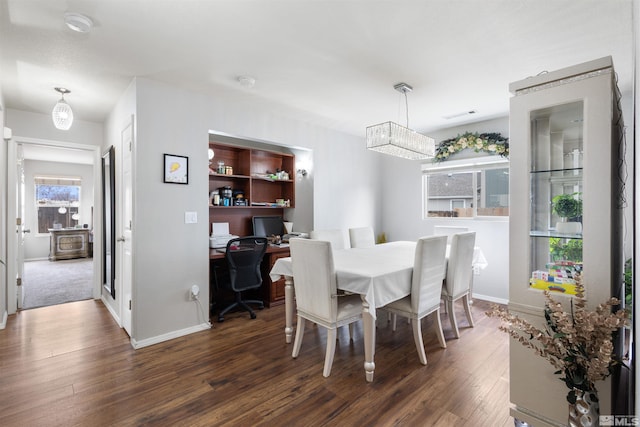 dining area featuring visible vents, baseboards, and dark wood finished floors