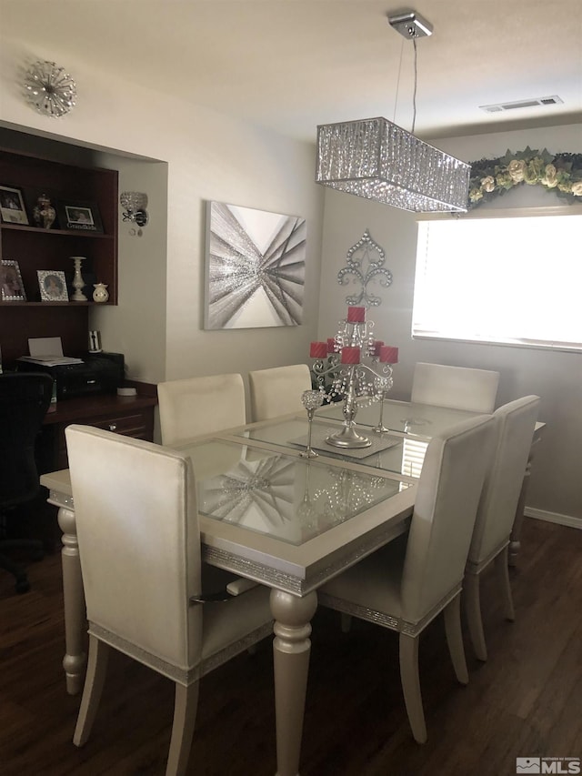 dining area featuring visible vents and wood finished floors