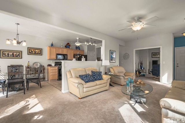 living room with light carpet and ceiling fan with notable chandelier