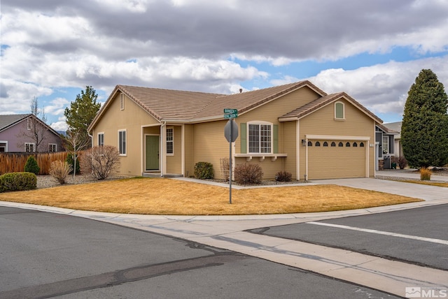 ranch-style house featuring driveway, a tile roof, a front lawn, and fence