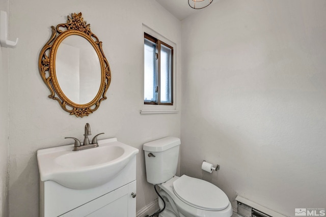 bathroom with a baseboard heating unit, toilet, and vanity