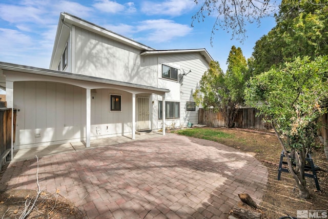 back of house featuring a patio and fence