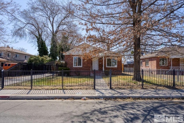 bungalow-style house with brick siding and a fenced front yard