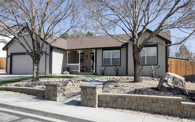 ranch-style house featuring a shingled roof, fence, a porch, driveway, and an attached garage