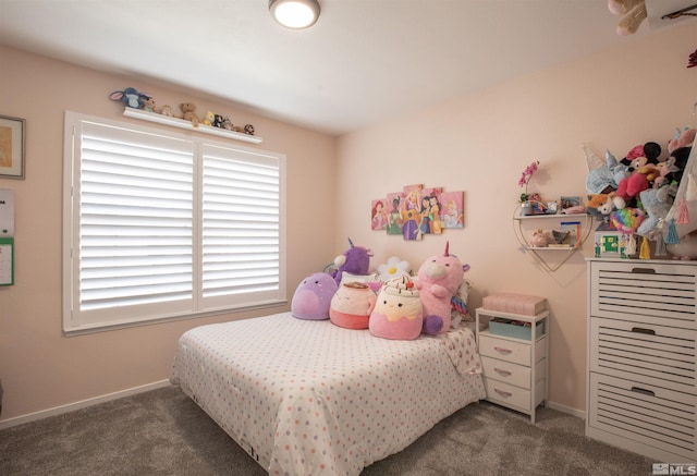 carpeted bedroom featuring baseboards and multiple windows