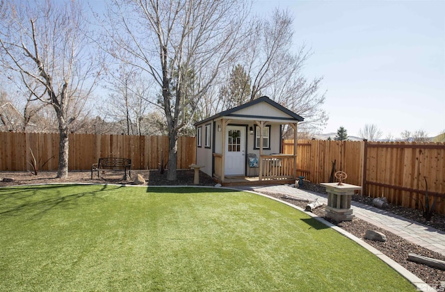 exterior space with an outbuilding and a fenced backyard