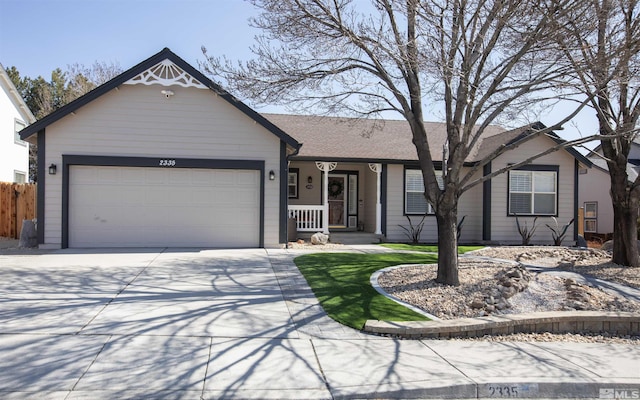 view of front of property featuring a garage, a porch, concrete driveway, and fence