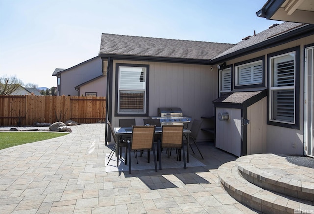 view of patio featuring outdoor dining area, area for grilling, and fence