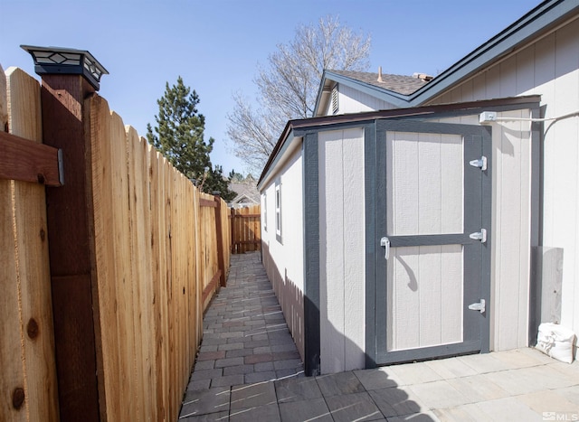 view of shed featuring fence