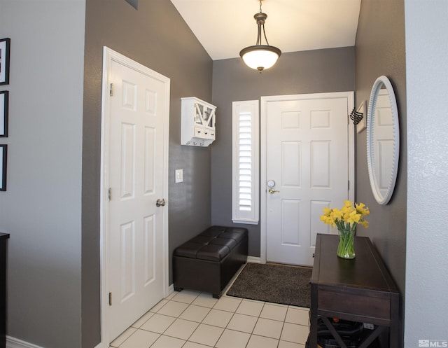 entrance foyer featuring light tile patterned flooring and baseboards