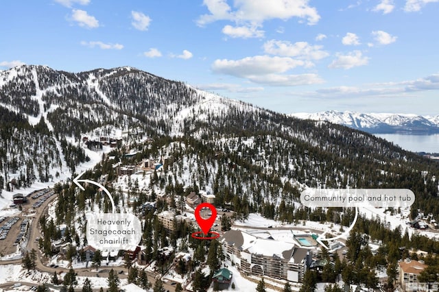 snowy aerial view with a mountain view