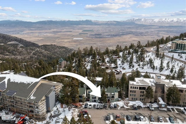 snowy aerial view with a mountain view