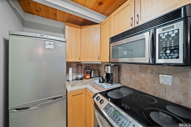 kitchen featuring light brown cabinets, tile countertops, wood ceiling, decorative backsplash, and stainless steel appliances