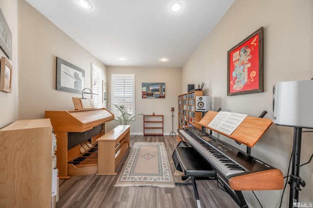 office featuring recessed lighting, wood finished floors, and baseboards