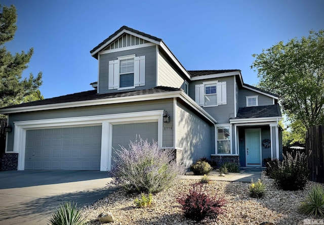 traditional-style house featuring a garage and driveway