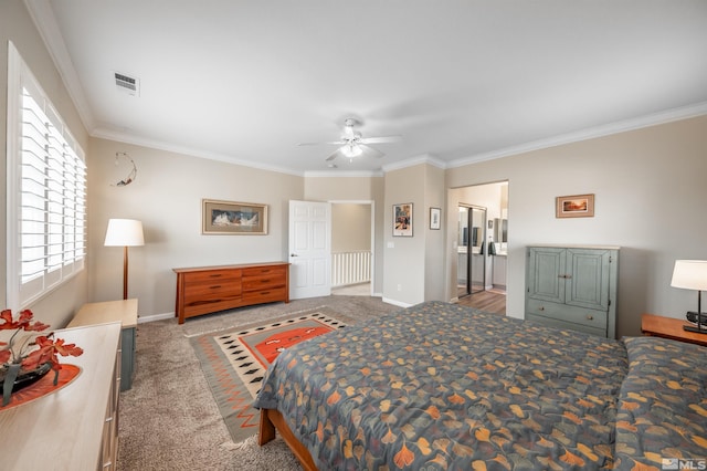 carpeted bedroom featuring baseboards, visible vents, ensuite bath, ceiling fan, and ornamental molding