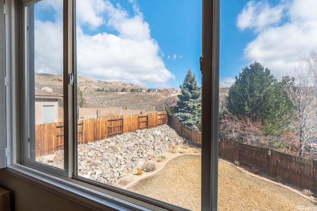 view of yard featuring a mountain view and a fenced backyard