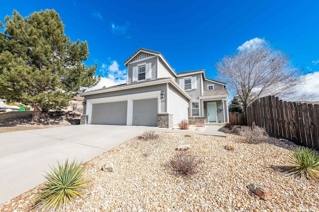 view of front of property with a garage, concrete driveway, and fence