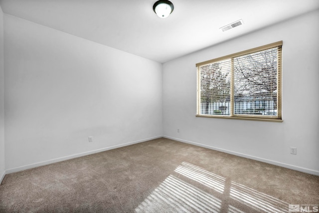 unfurnished room featuring carpet flooring, baseboards, and visible vents