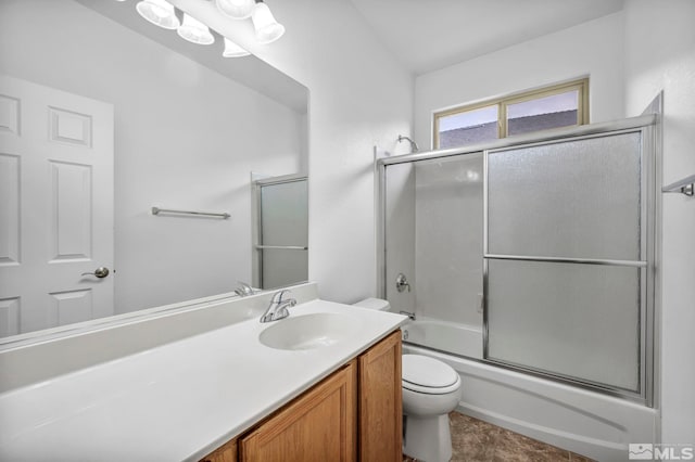 bathroom with bath / shower combo with glass door, toilet, and vanity