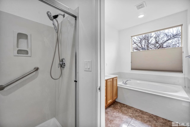 bathroom with tile patterned floors, visible vents, a garden tub, a shower stall, and vanity