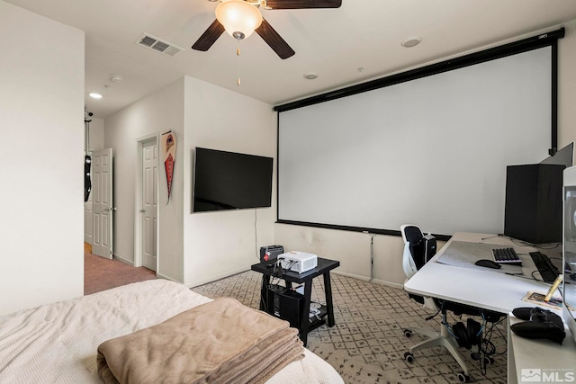 cinema featuring visible vents, light colored carpet, baseboards, and ceiling fan