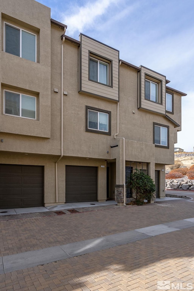 view of property with stucco siding and an attached garage