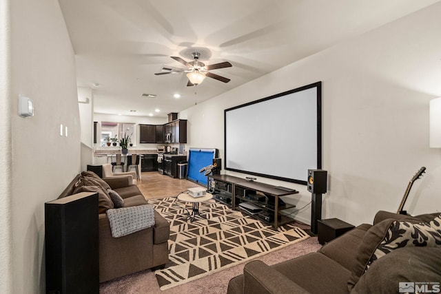 cinema room with visible vents and a ceiling fan